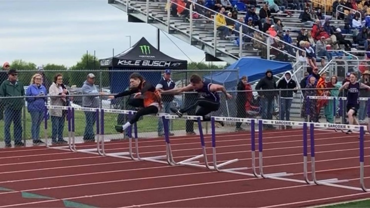 Running hurdles at sectional track meet